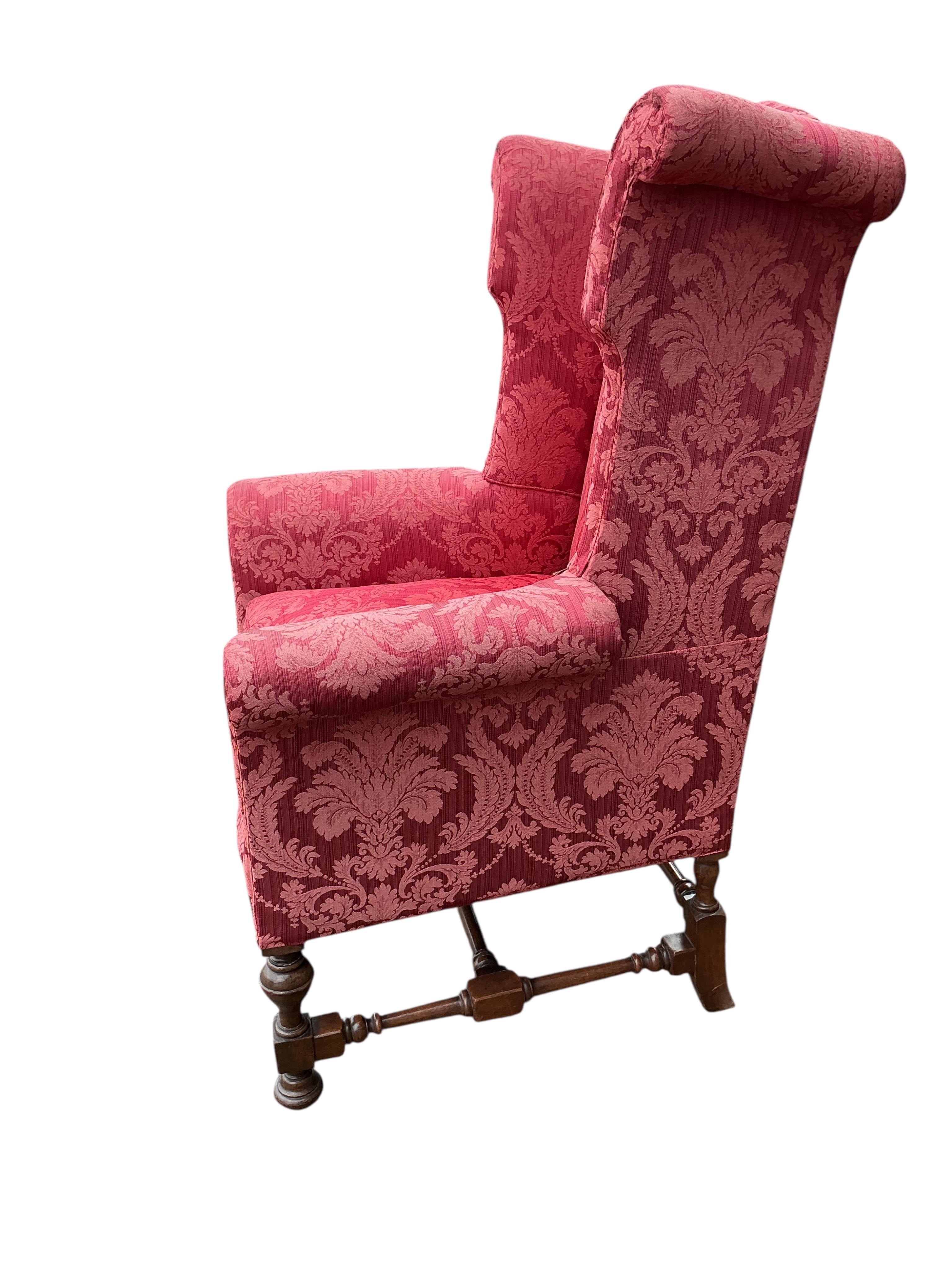 A pair of early 20th century Jacobean Revival upholstered wing armchairs, width 81cm, depth 75cm, height 127cm